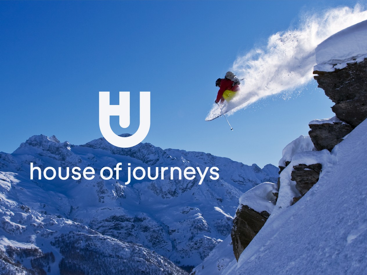 House of Journeys logo lockup over a mountain skiing photograph
